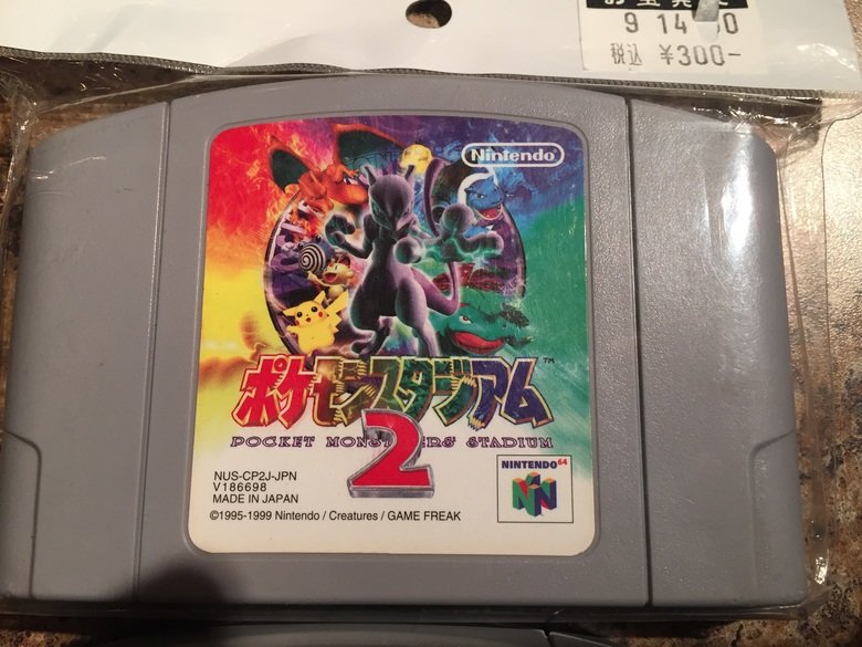 My friend brought me goodies from Japan!. Here's it all together! Pocket Monsters Film Comic The Movie! 100% color! Then I got these poker chips? Seriously don'